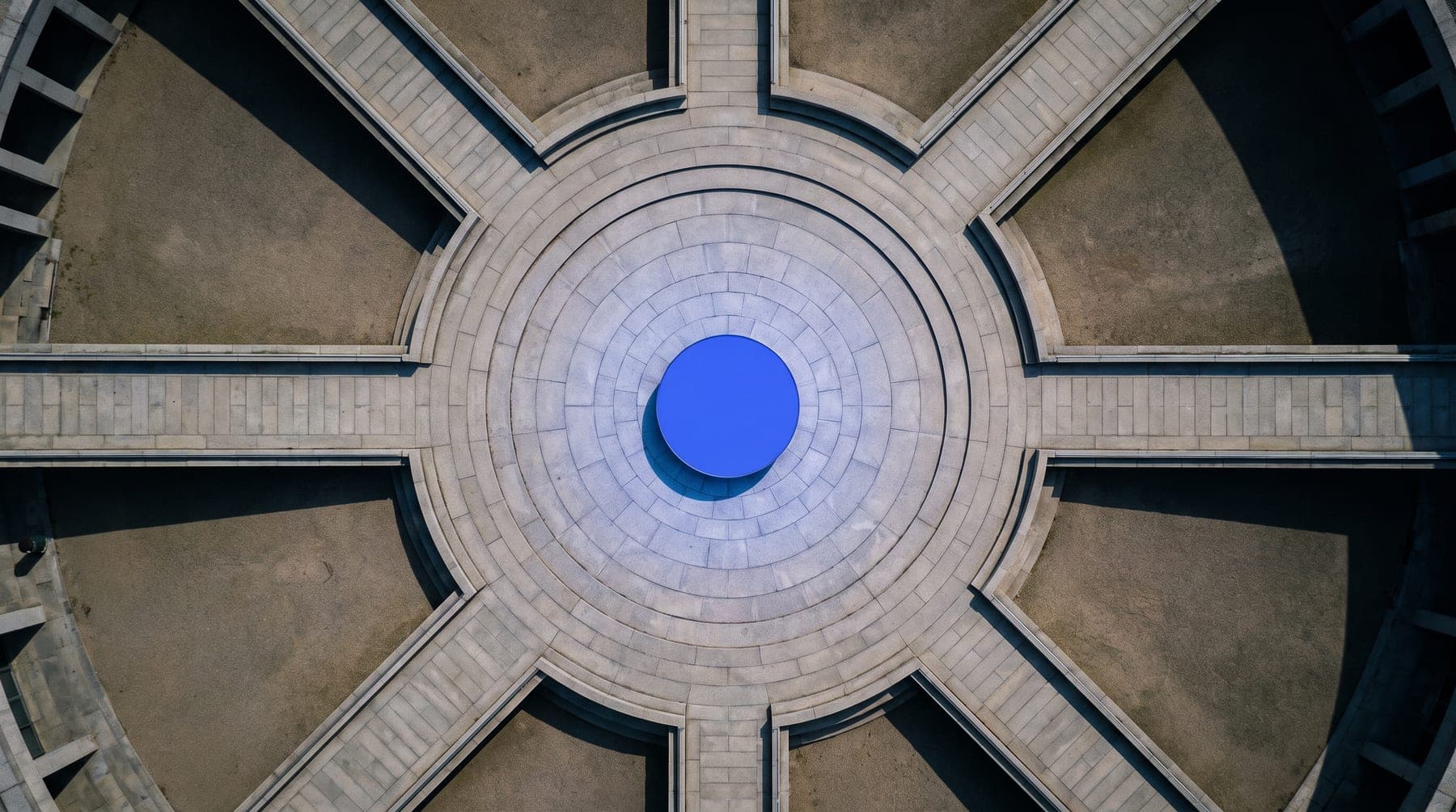 Overhead view of walkways converging into one central court with an ultramarine core